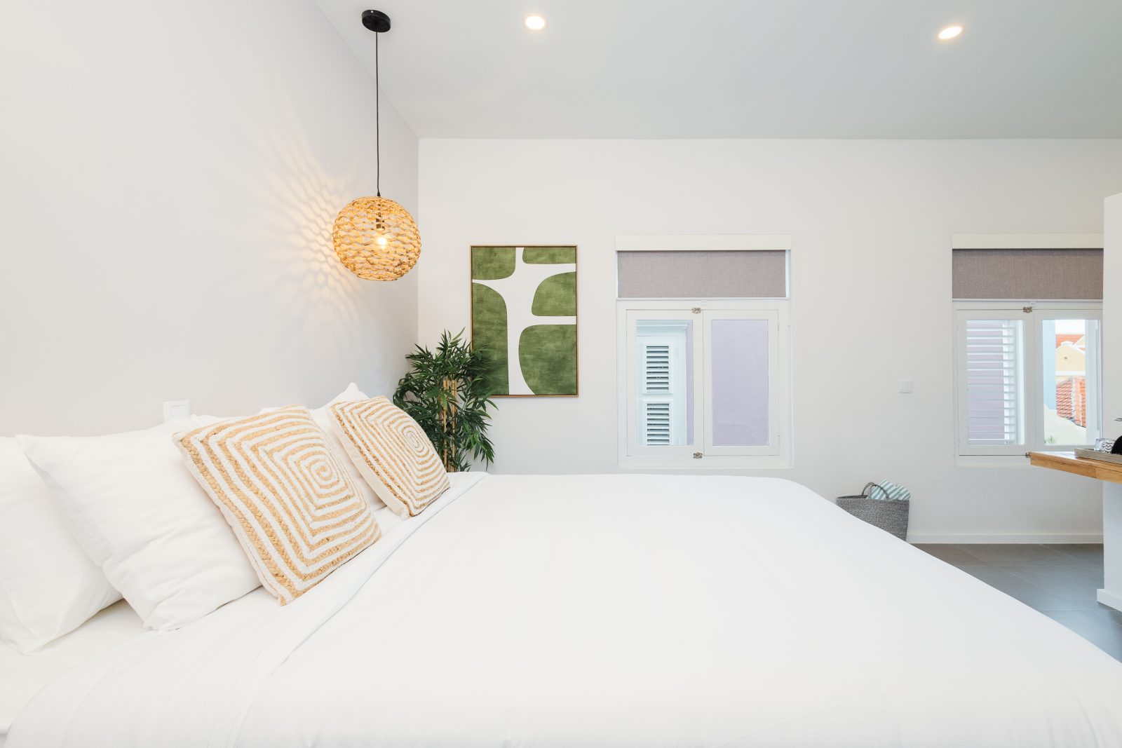 The Serenity Suite at Pietermaai Oasis — king bed in soft morning light